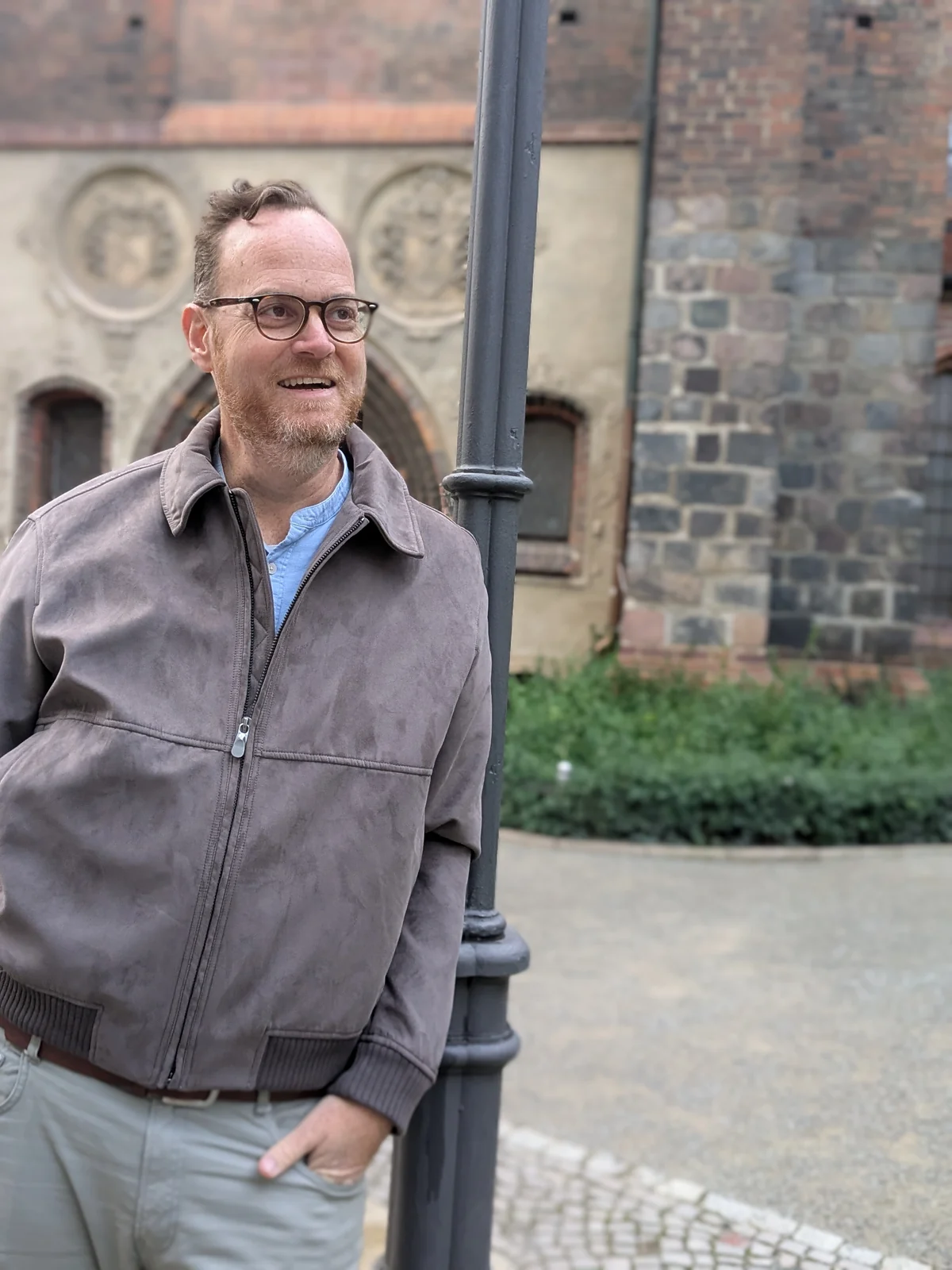 Eyal Edelmann smiling beside a lamppost in Berlin