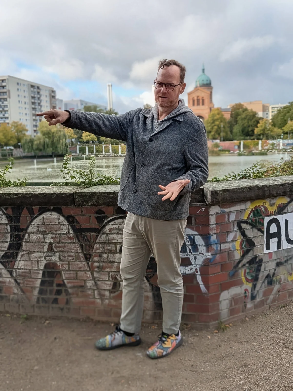 Eyal pointing out a sight while sharing a story in Berlin